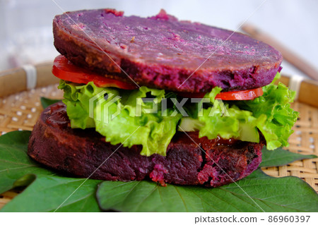 vegan hamburger from violet sweet potato with tomato, salad 86960397