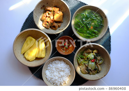 Vietnamese vegan food, rice bowl, fried aubergine, seitan cook with sauce, spinach soup Vietnamese vegan food, rice bowl, fried aubergine, seitan cook with sauce, spinach soup 86960408