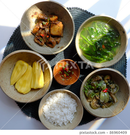 Vietnamese vegan food, rice bowl, fried aubergine, seitan cook with sauce, spinach soup 86960409