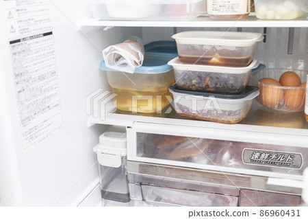 Inside the refrigerator with side dishes divided into tappers Inside the refrigerator with side dishes divided into tappers 86960431