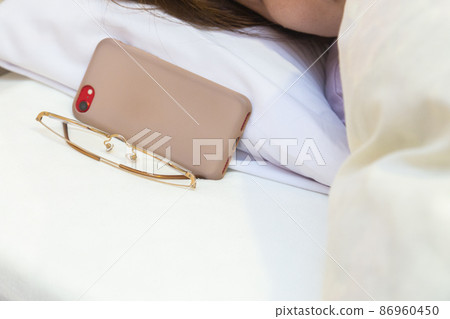 Sleeping woman's bedside 86960450