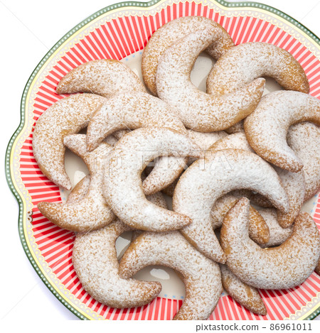 Traditional German or Austrian Vanillekipferl vanilla kipferl cookies on decorated ceramic plate Traditional German or Austrian Vanillekipferl vanilla kipferl cookies on decorated ceramic plate 86961011