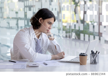 Businessman's hand presses on a laptop keyboard, World of technology and internet communication, Using computers to conduct financial transactions because the convenience and speed. Businessman's hand presses on a laptop keyboard, World of technology and internet communication, Using computers to conduct financial transactions because the convenience and speed. 86961344