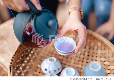 Teapot and tea cups on rattan at home Teapot and tea cups on rattan at home 86962395