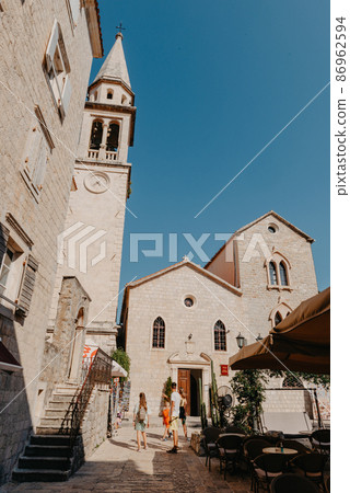 ld Town, Budva, Montenegro. Picturesque square in the well preserved medieval Old town with shops, cafes and restaurants in the Balkans. The view of Budva medieval fortress of St. Mary, Citadel 86962594
