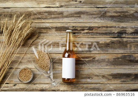 A bottle of beer and grain. Top view. Free space for text. A bottle of beer and grain. Top view. Free space for text. 86963516