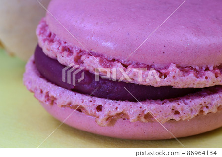 Den Helder, the Netherlands. January 2022. A stack of macarons on an yellow background. 86964134
