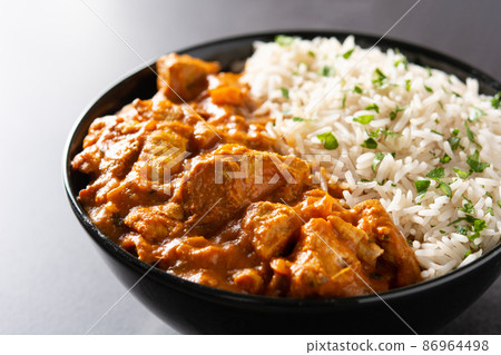 Indian butter chicken in black bowl 86964498
