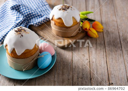 Traditional Easter cake, colorful eggs and tulips Traditional Easter cake, colorful eggs and tulips 86964702