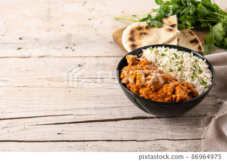 Indian butter chicken in black bowl Indian butter chicken in black bowl 86964975