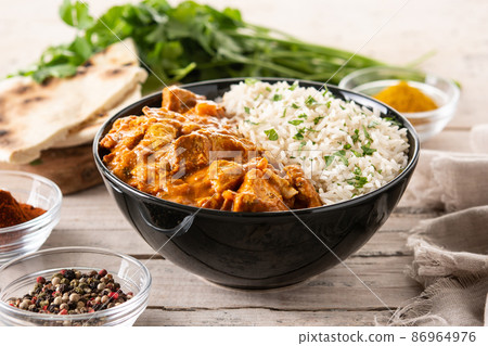 Indian butter chicken in black bowl Indian butter chicken in black bowl 86964976