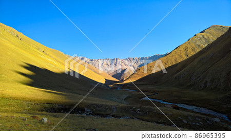 Sunset view to Tash-Rabat river and valley in Naryn province, Kyrgyzstan 86965395