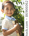 little boy smiling while hugging book looking at camera 86966062