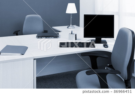 laptop and computer on desk in a modern office laptop and computer on desk in a modern office 86966451