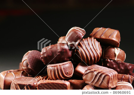 stack of many dark chocolate on black stack of many dark chocolate on black 86968691