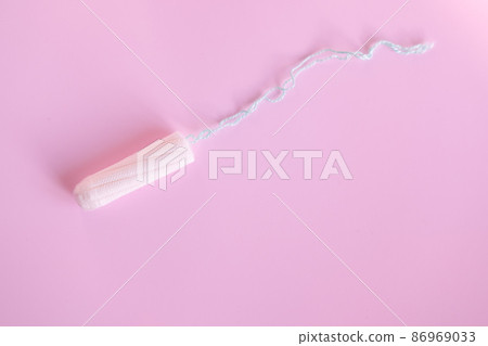 female tampon on a pink background. Hygienic white tampon for women. 86969033