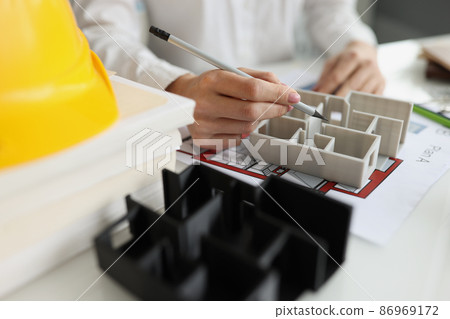Hands with a pen over the layout and building plan 86969172