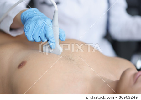 Hands on the chest of a man, ultrasound of the heart 86969249