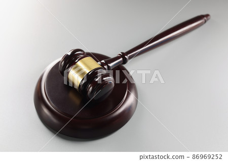Red judge's gavel on a gray background 86969252