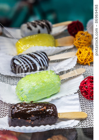 candy on a stick with different flavors on the counter 86969498