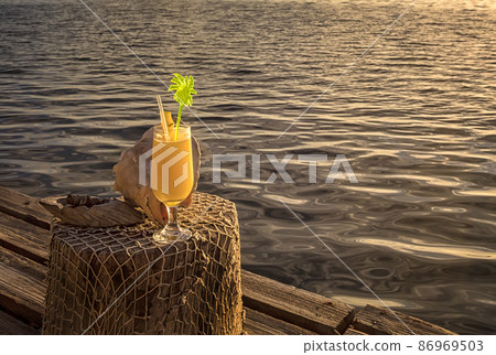 Cocktail on vacation on a tropical island. Cocktail on vacation on a tropical island. 86969503