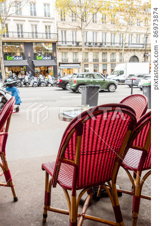 Mesh-patterned chairs and tables lined up in front of the store, the streets of Paris Mesh-patterned chairs and tables lined up in front of the store, the streets of Paris 86973874