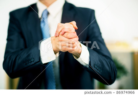 Businessman at the office with his hands folded. Willingness to friendship and cooperation. 86974966