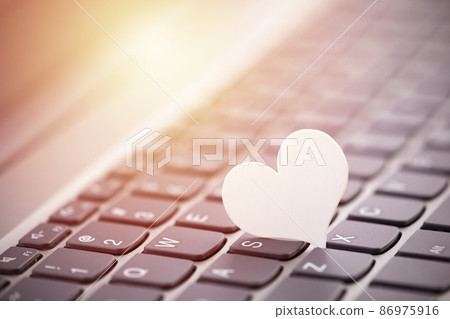 Small white paper heart on computer keyboard. Internet dating concept. Small white paper heart on computer keyboard. Internet dating concept. 86975916