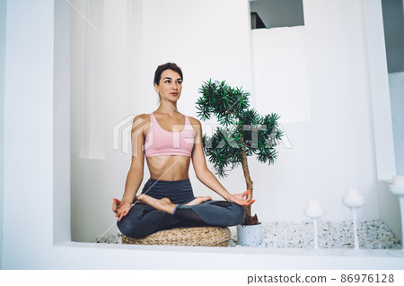 Young Caucasian woman enjoying morning workout for meditate in asana and relaxing from daily routine Young Caucasian woman enjoying morning workout for meditate in asana and relaxing from daily routine 86976128