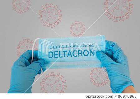 A doctor in gloves holds a mask with the text Delta and Omicron Deltacron. The concept of a new mutation variant of the infectious disease covid-19 86976965