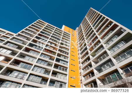 high-rise apartment building facade , real estate low angle view high-rise apartment building facade , real estate low angle view 86977326