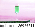 Blue-green champagne glass, white light and copy space that blend into the pink landscape 86986711