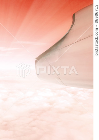 A wonderful view from the window of an airplane: red-orange and light like the setting sun A wonderful view from the window of an airplane: red-orange and light like the setting sun 86986715