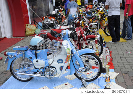 PENANG, MALAYSIA -JULY 9, 2022: Beautiful underbone motorcycles are being displayed to the public. This motorcycle has been decorated and customized by its owner according to their tastes. 86987024
