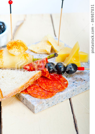 mix cold cut on a stone with fresh pears 86987831