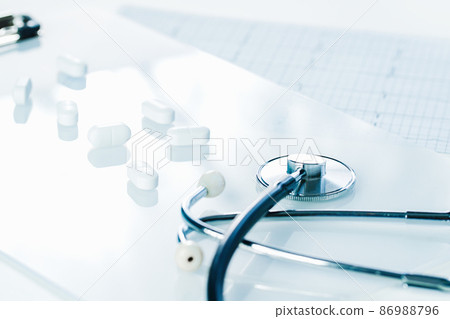 Background of white tablets or pills on the table. Medicine and pharmacy 86988796