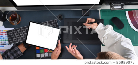 Team of graphic designer working with digital tablet and discussing on new project together. 86989073
