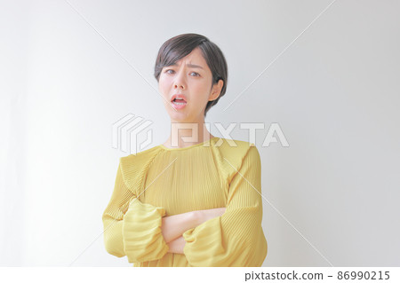 An angry woman with her arms folded 1 86990215