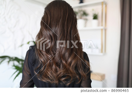 Beautiful long hair of a young brunette woman Beautiful long hair of a young brunette woman 86990465