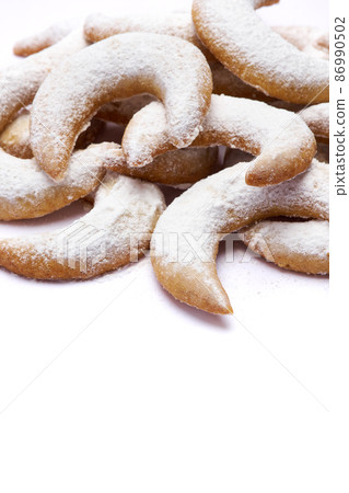 Traditional German or Austrian Vanillekipferl vanilla kipferl cookies isolated on white background Traditional German or Austrian Vanillekipferl vanilla kipferl cookies isolated on white background 86990502