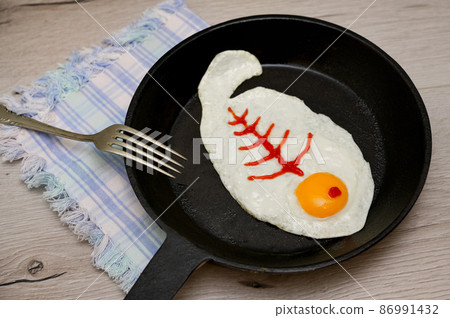 Abstract breakfast fried egg with Fish skeleton Abstract breakfast fried egg with Fish skeleton 86991432