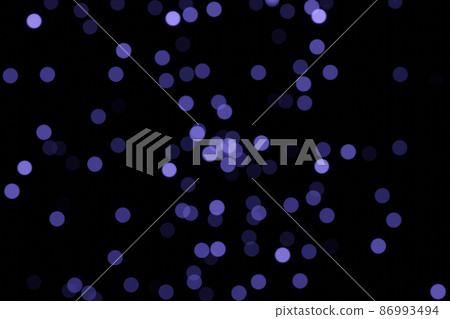 Defocused bokeh lights on black background, an abstract naturally blurred backdrop for Valentines Day or birthday party. Festive light texture. Violet blue garland in blur. Color 2022 Defocused bokeh lights on black background, an abstract naturally blurred backdrop for Valentines Day or birthday party. Festive light texture. Violet blue garland in blur. Color 2022 86993494