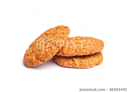 Oat vanilla sugar cookies isolated on white background. Close-up view of brown yellow snacks. Macro shot of beige biscuit cakes for your design Oat vanilla sugar cookies isolated on white background. Close-up view of brown yellow snacks. Macro shot of beige biscuit cakes for your design 86993495