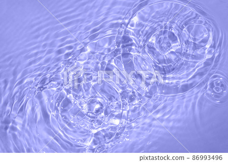 Circles on water. Blue round shadows. Blurred background made with water and light in monochrome. Pureness and freshness concept. Trendy violet color of the year 2022 Circles on water. Blue round shadows. Blurred background made with water and light in monochrome. Pureness and freshness concept. Trendy violet color of the year 2022 86993496
