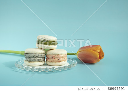 Flowers and macarons on a mint background Flowers and macarons on a mint background 86993591