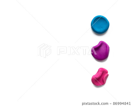Three color modeling clay plasticine finger textured flatten and crumpled balls or lumps isolated on white background with shadow. Top view, copy space. Stage concept. 86994841
