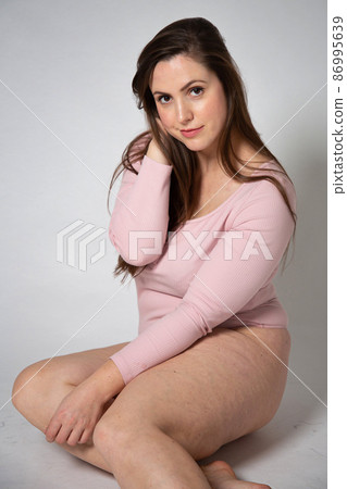 Woman in pastel pink on grey 86995639