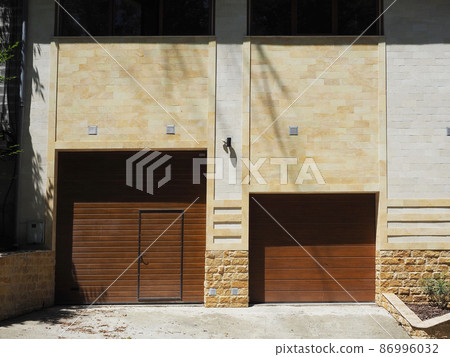 Automatic garage gate and front door in a private apartment building in a modern style 86996032