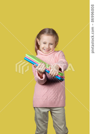 Portrait of happy elementary age school girl smiling and looking at the camera 86996808