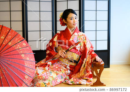 二十多歲的和服女人在室內拿著折扇 二十多歲的和服女人在室內拿著折扇 86997172